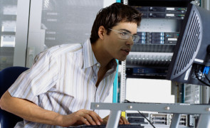 IT Worker Using Computer in Server Room